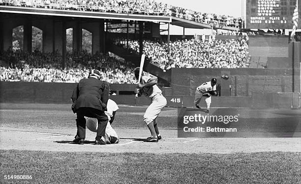 The first pitch of the 1959 World Series is delivered by Whitesox pitcher Early Wynn to the Dodger's Him Gilliam, who takes it for a called strike....