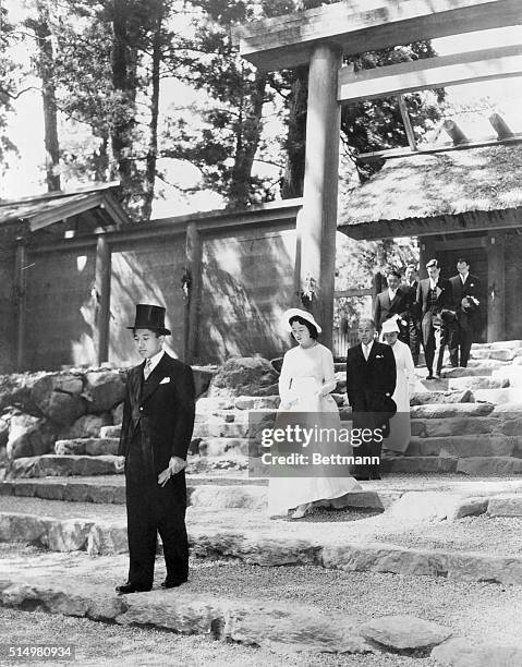 Akihito and Wife Visit Shrine. Mie Prefecture, Japan: Crown Prince Akihito , followed by his wife, Princess Michiko, leads a procession at the Ise...