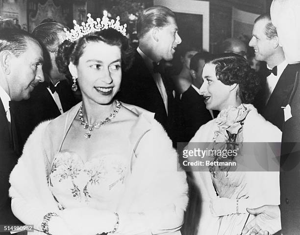 Her Majesty the Queen with Princess Margaret and the Duke of Edinburgh at Tivoli Theater. The Duke is conversing with Lord Harewood.