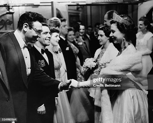 Queen Elizabeth II is shown shaking hands with Frankie Laine, one of the American performers who appeared at the 25th royal variety show at London's...