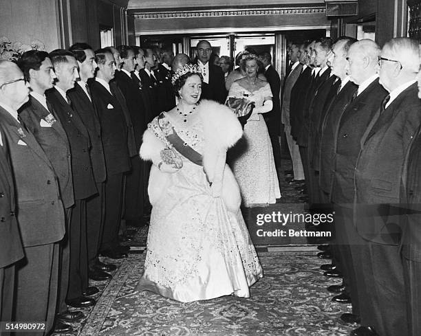 Britain's Queen Mother Elizabeth walks through a guard of honor formed by former Buckingham Palace guards as she arrives at the Waldorf-Astoria Hotel...