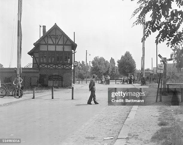 West German sentries patrol a new barricade in front of the common barrier on a highway running from the West Zone to the east. The new barricade is...