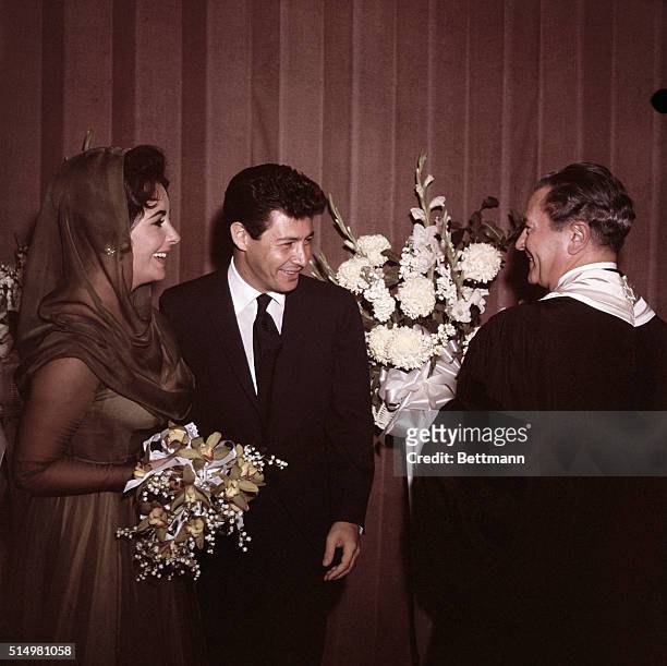 Las Vegas, NV- Eddie Fisher and Elizabeth Taylor are shown after their wedding at Temple Beth Shalom. They are shown facing the rabbi, smiling. No...