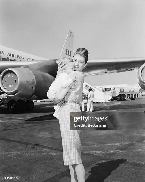 Actress Audrey Hepburn and son Sean, 7 months, leave for Rome via jetliner. She eventually was to join husband Mel Ferrer in Yugoslavia.