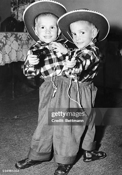 Siamese twins Ronnie and Donnie Galyon pose in their cowboy suits on