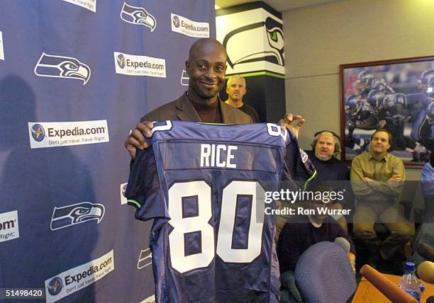 Receiver Jerry Rice holds up his new Seattle Seahawks jersey after the Seattle Seahawks announced a trade on October 19, 2004 with the Oakland...