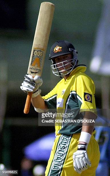 Australian batsman Mark Waugh waves his bat to the crowd on completing his century during the second one-day international cricket match against...