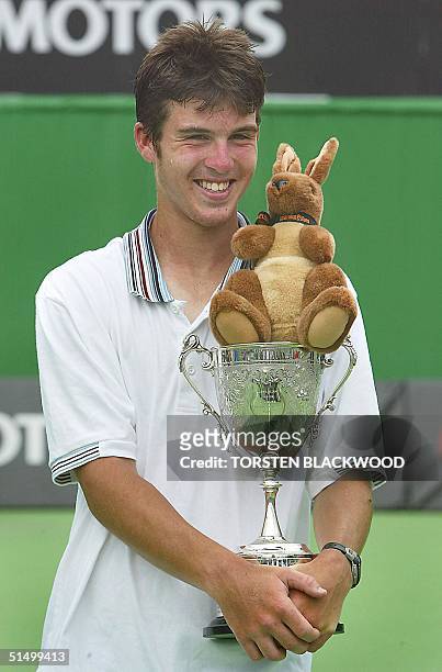 Clement Morel of France poses with the winner's trophy following his victory over Todd Reid of Australia in the junior boys singles final at the...