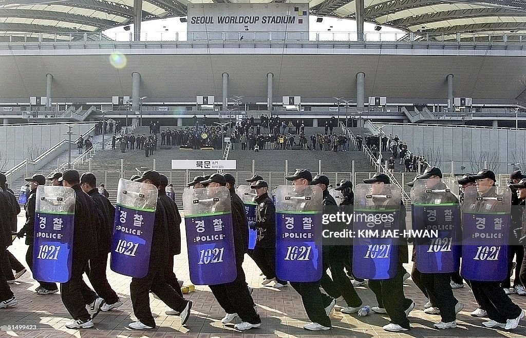 Hooligans Riot South Korean anti-hooligan riot police run past stands of the World ...