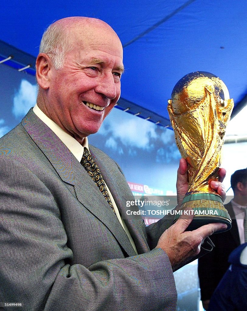 England's soccer legend Bobby Charlton holds the F