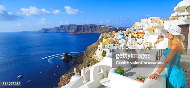 woman on rooftop terrace of town oia at santorini - mediterranean-blue-roof-santorini stock pictures, royalty-free photos & images