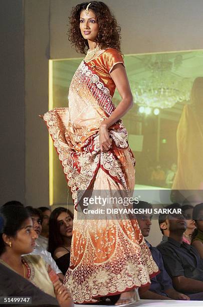 Model shows a traditional saris during a fashion show in Madras 07 September 2002. The show was organised to promote the fashions and work of of...