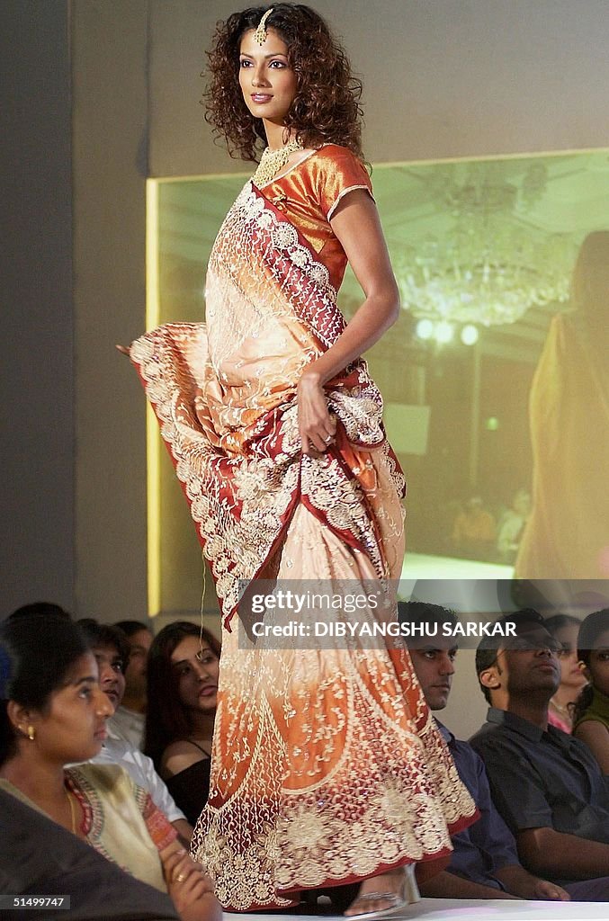 A model shows a traditional saris during a fashion