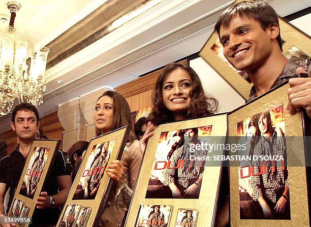 Bollywood actors Amir Khan , Karishma Kapoor former miss India Diya Mirza and actor Vivek Oberoi hold posters of the movie 'DUM' in Bombay, 29...