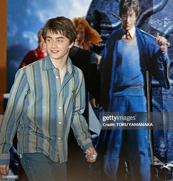 British actor Daniel Radcliffe walks past poster of their new movie "Harry Potter and the Chamber of Secrets" prior to a press conference in Tokyo,...
