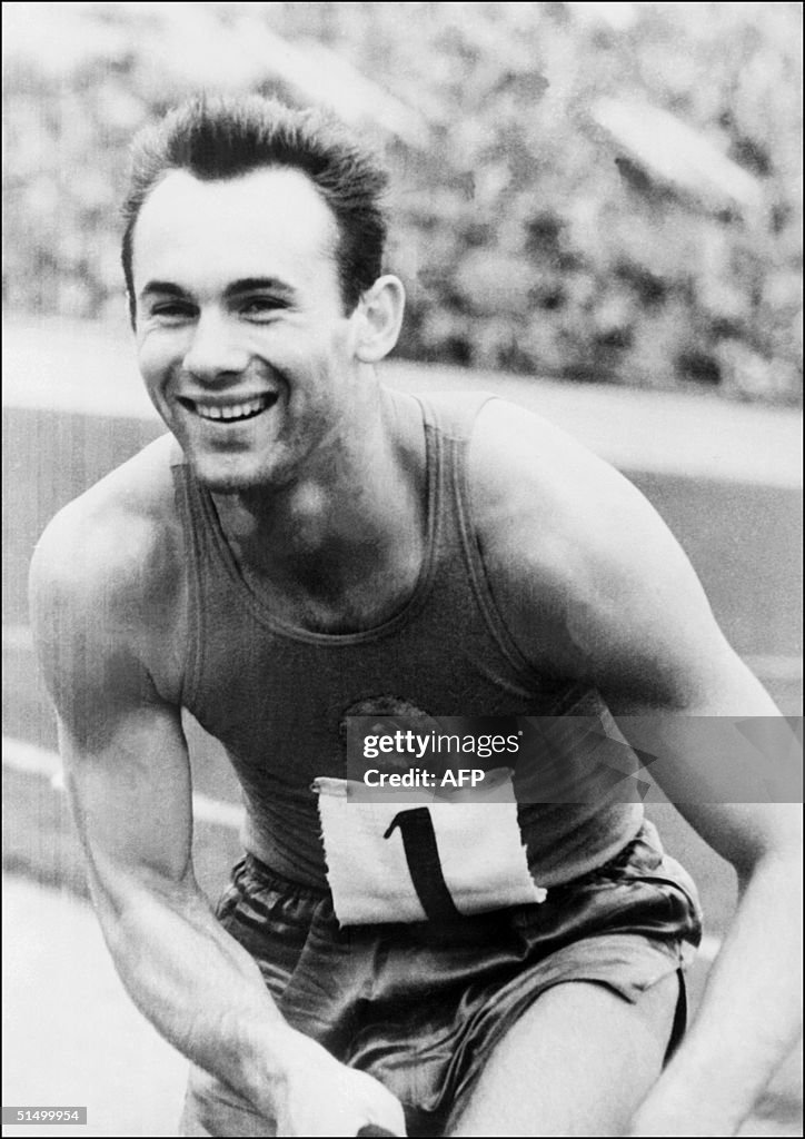 Soviet athlete Valery Brumel smiles as he just set