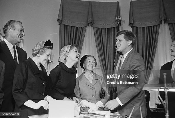 Admirers. Washington: Actresses June Havoc and Helen Hayes look admiringly at President Kennedy when they call at the White House with a group...