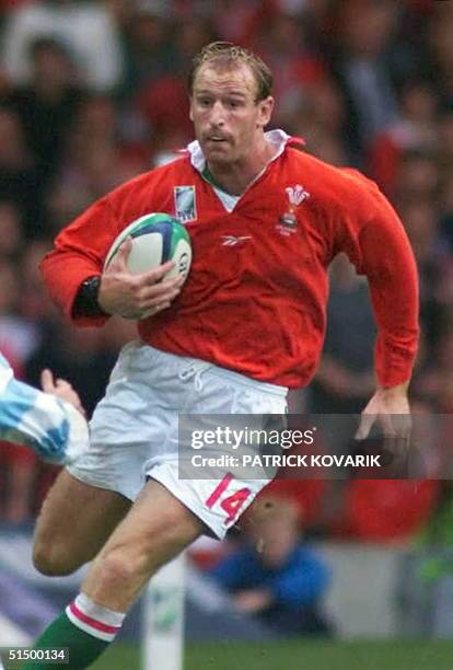Welsh winger Gareth Thomas runs with the ball during the opening match of the Rugby World Cup between Wales and Argentina at the brand new Millennium...