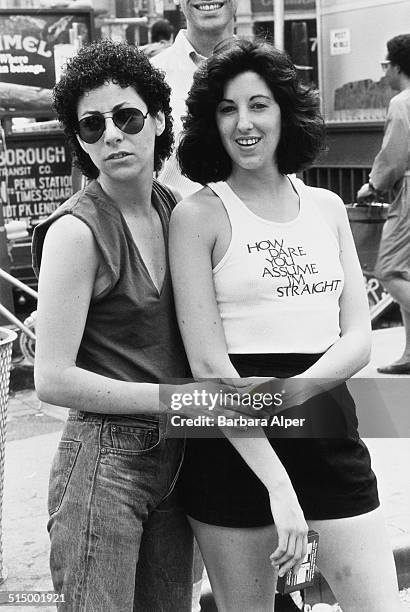 Gay Pride Day in New York City, June 1982. One woman wears a t-shirt with the slogan 'How dare you assume I'm straight'.