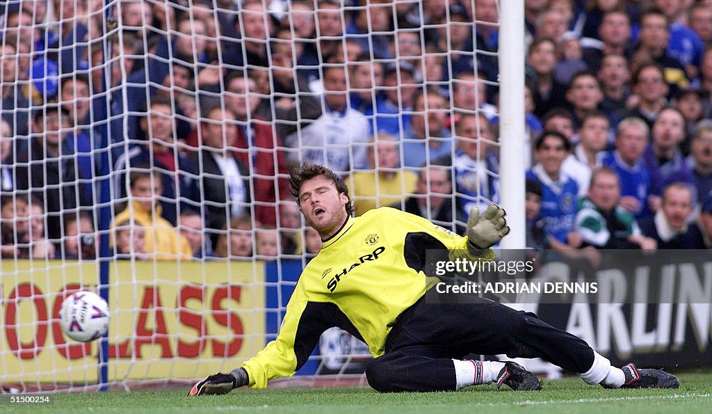 Manchester United's goalkeeper Massimo Taibi lets