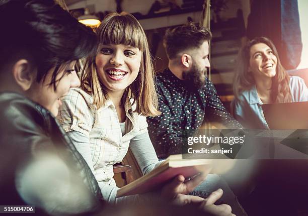 teenage friends at the coffee bar - book discussion stock pictures, royalty-free photos & images