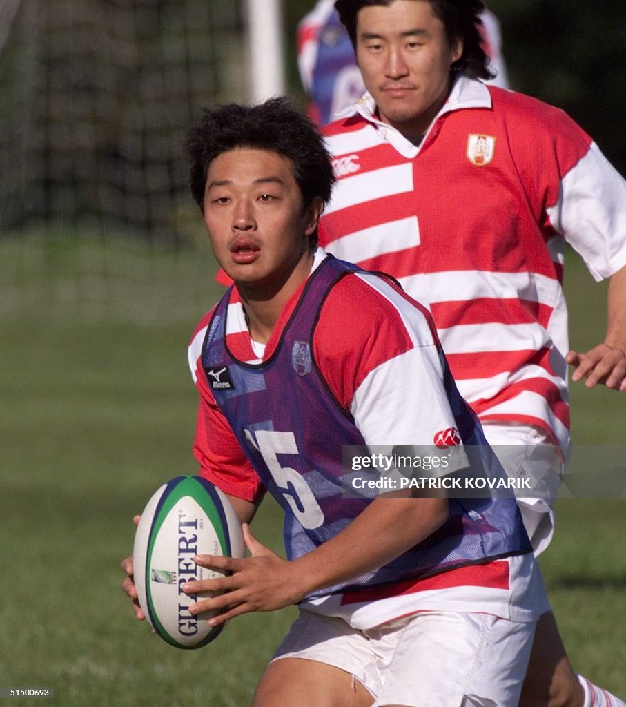 Japanese fly-half Kensuke Iwabuchi prepares to pas