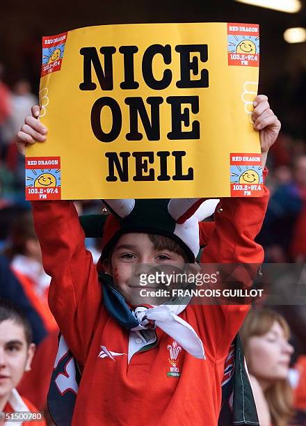 Welsh young rugby fan displays a poster celebrating Neil Jenkins becoming the new world record holder of the greatest number of points scored in...