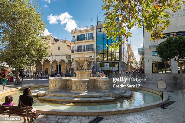 relaxing at morozini fountain, heraklion, greece - heraklion stock pictures, royalty-free photos & images