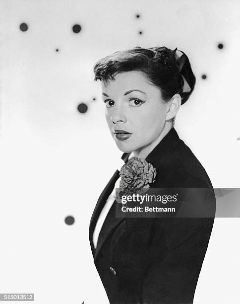 New bride with a new hairdo, and happier and sprightlier than ever is Judy Garland, shown in the first informal portraits she has posed for in...