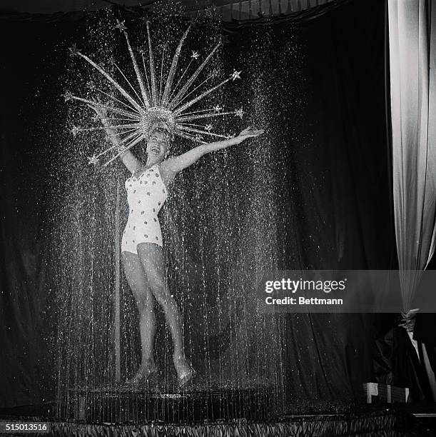 Stellar Shower Opens Esther Williams Show: Las Vegas, Nevada: Actress Esther Williams wear a glittering headdress here as she stands under under a...