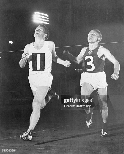 Chris Chataway, left, is shown beating V. Kuts, of Moscow, USSR, in the 5,000 meter event at the London vs. Moscow athletic meet at White City....