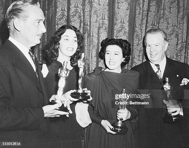 Academy Award winners holding their statues from left: Paul Lukas for Watch on the Rhine; Jennifer Jones Song of Bernadette; Katina Paxinou for For...