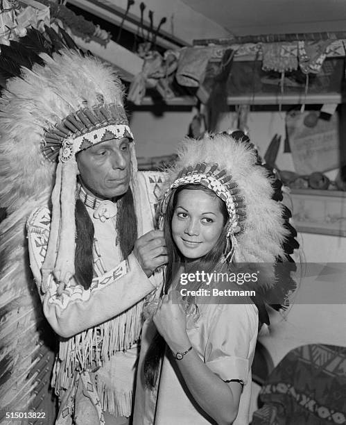 Nancy Kwan, known to movie-goers as "Suzie Wong," is inducted into the Cherokee Indian tribe by Iron Eyes Cody.