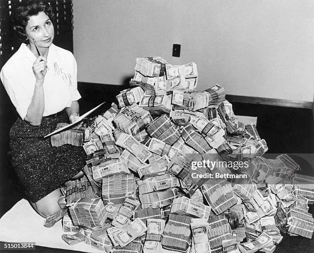 Marie Reed of the Federal Savings and Loan Association sits next to a million dollars in cash.