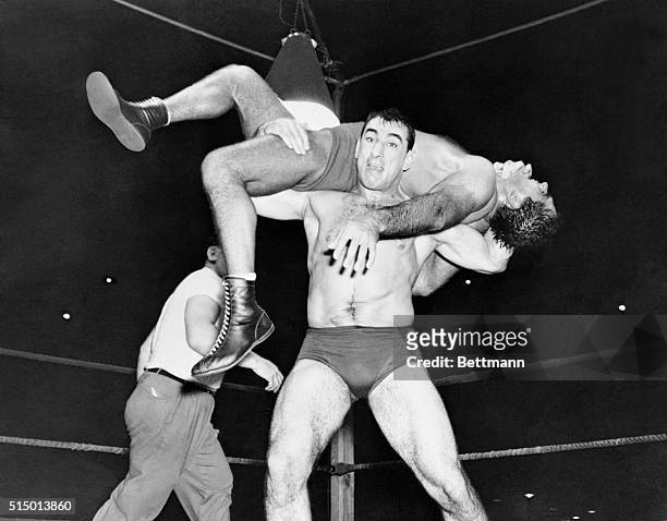 Grim faced Antonio Rocca applies a back-breaker to heavyweight wrestling champion Lou Thesz to win the second fall at Griffith Stadium. Thesz had...
