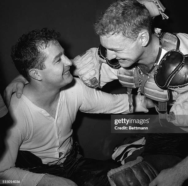 Heroes of the Chicago Black Hawks, goalie Glenn Hall and Bobby Hull exchange congratulations in dressing room after eliminating Montreal Canadiens...