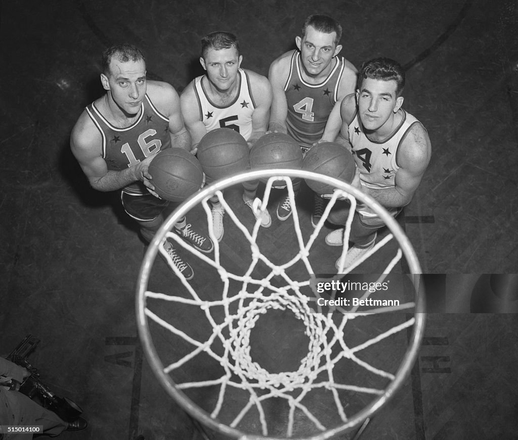 Basketball Players Posing Underneath the Net