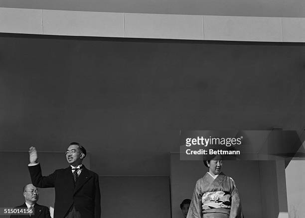 Emperor Hirohito of Japan and Empress Nagako are shown as they appeared on a special stand at the Imperial Palace to acknowledge the greetings of...