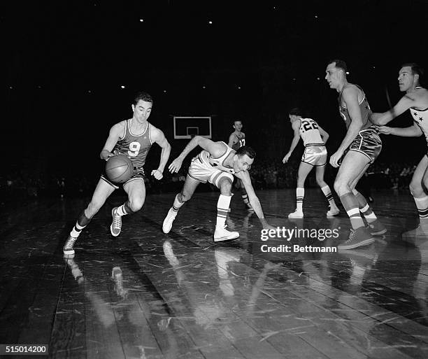 Rochester's Bob Wanzer, of the West All-Stars, dribbles past Bob Cousy, Boston, of the Eastern Team, during the 1955 All-Star game at Madison Square...