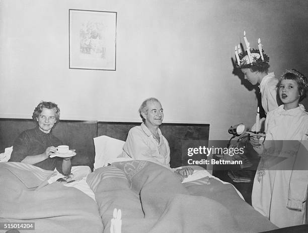 Dr. Linus Pauling, of the California Institute of Technology, winner of the Nobel Prize in chemistry, and his wife, are shown being visited by two...