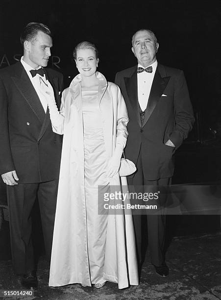 Actress Grace Kelly, star of the movie The Country Girl, arrives at the premiere of the picture with her father, John Brenden Kelly , and brother,...