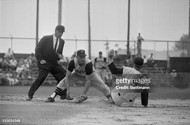 Roger Maris of the New York Yankees is tagged out going into second base by short stop Dick Groat of the Pittsburgh Pirates in fourth inning of their...
