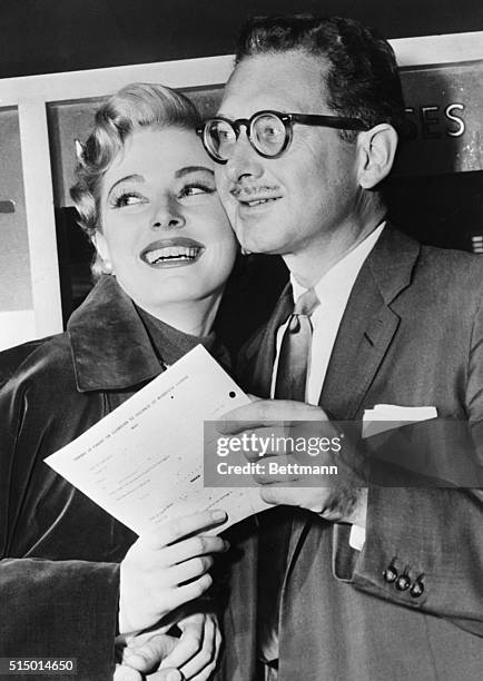 Actress Eleanor Parker, heading for her third try at matrimonial success, and artist Paul Clemens, are shown after they took out their wedding...