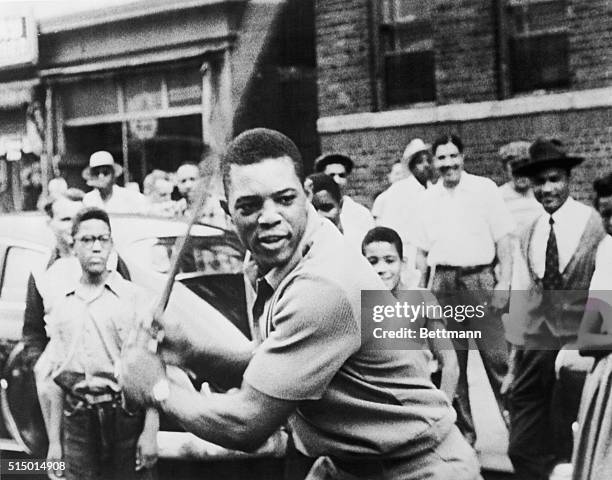 Willie Mays playing stick ball with Harlem kids.