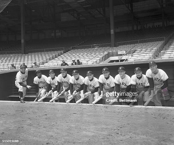 Pittsburgh Pirates at Polo Grounds- in the dugout left to right: Manager Bobby Bragan, Roberto Clemente, outfielder, Dick Grant, short stop, Dale...