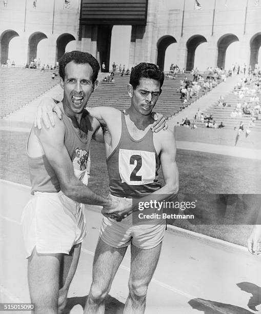 Runner John Landy congratulates South African hunter Jim Bailey after he won a special one-mile race.