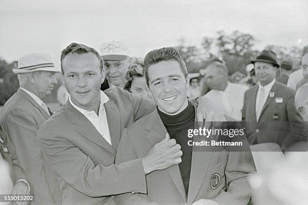 Defending champion Arnold Palmer helps Gary Player adjust his new green coat . After Player won the 1961 title with a 72-hole total of 280, Palmer...