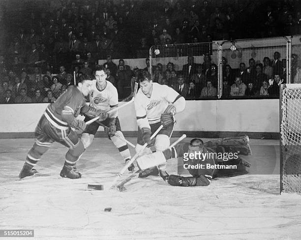 Drive That Failed. Detroit, Michigan: Ranger goalie Lorne Worsley deflects the puck to foil the attempt of Red Kelly of the Red Wings and teammate...