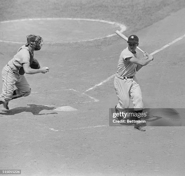 Angels' catcher Earl Averill reaches to tag out Roger Maris of the Yankees during first inning of game here August 9th. Maris struck out but the...