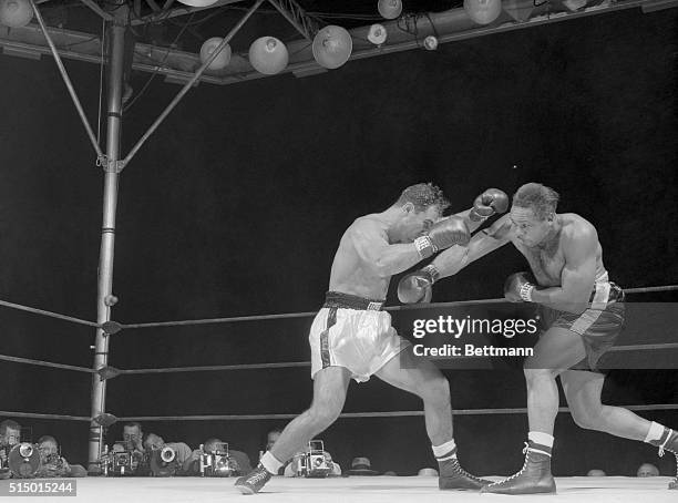 Moore Goes for the Midriff. New York, New York: Archie Moore throws a right to the stomach of the onrushing Rocky Marciano in the second round of...